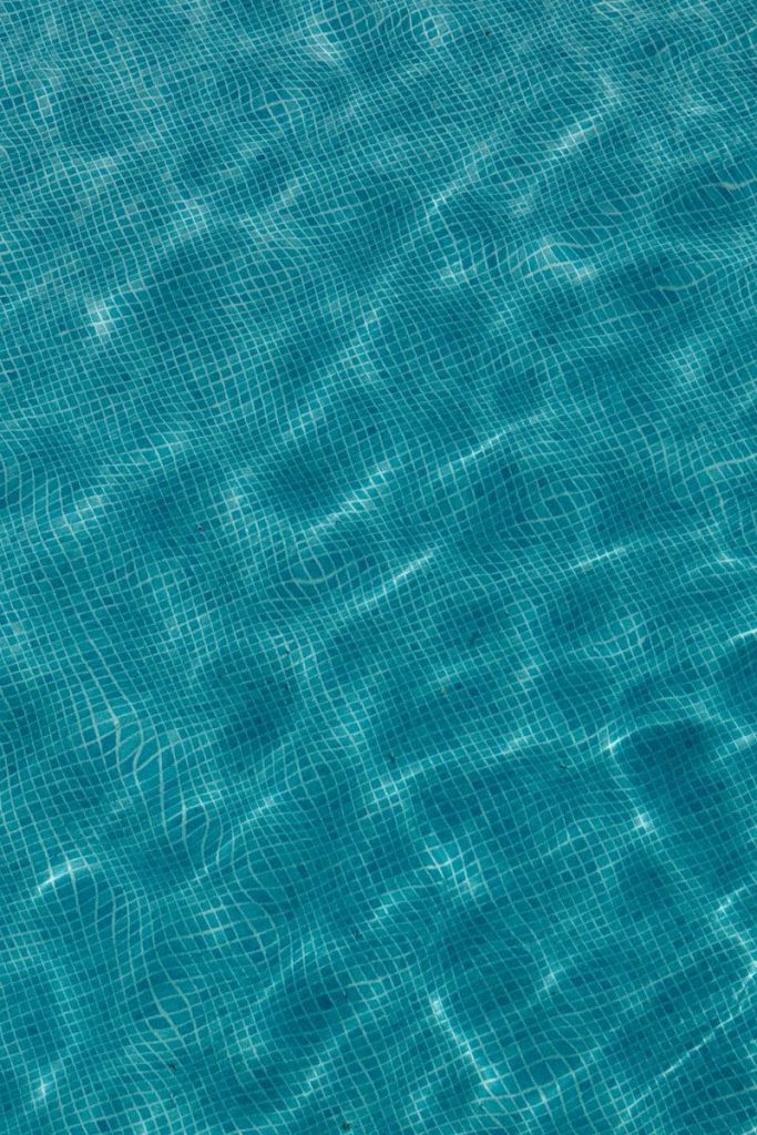 Rippling blue water surface with tiled pattern below